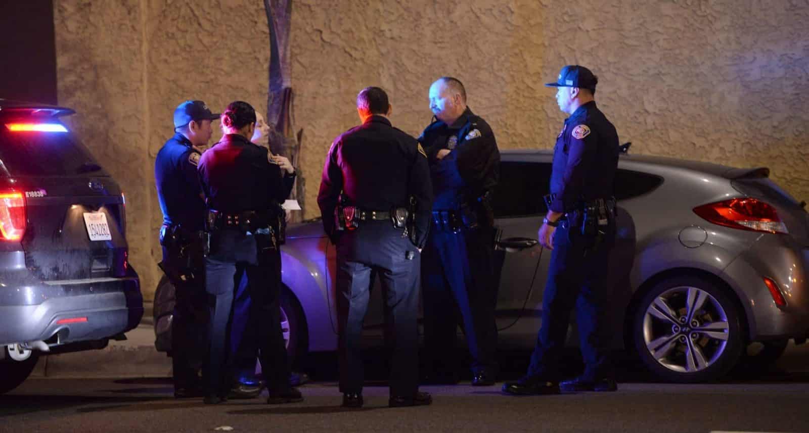 Long Beach Police officers at Redondo Avenue, between Broadway and Vista Street, where officers pulled over a car with a stabbing victim inside. Long Beach California, Thursday, April 4, 2019. Photo by Stephen Carr