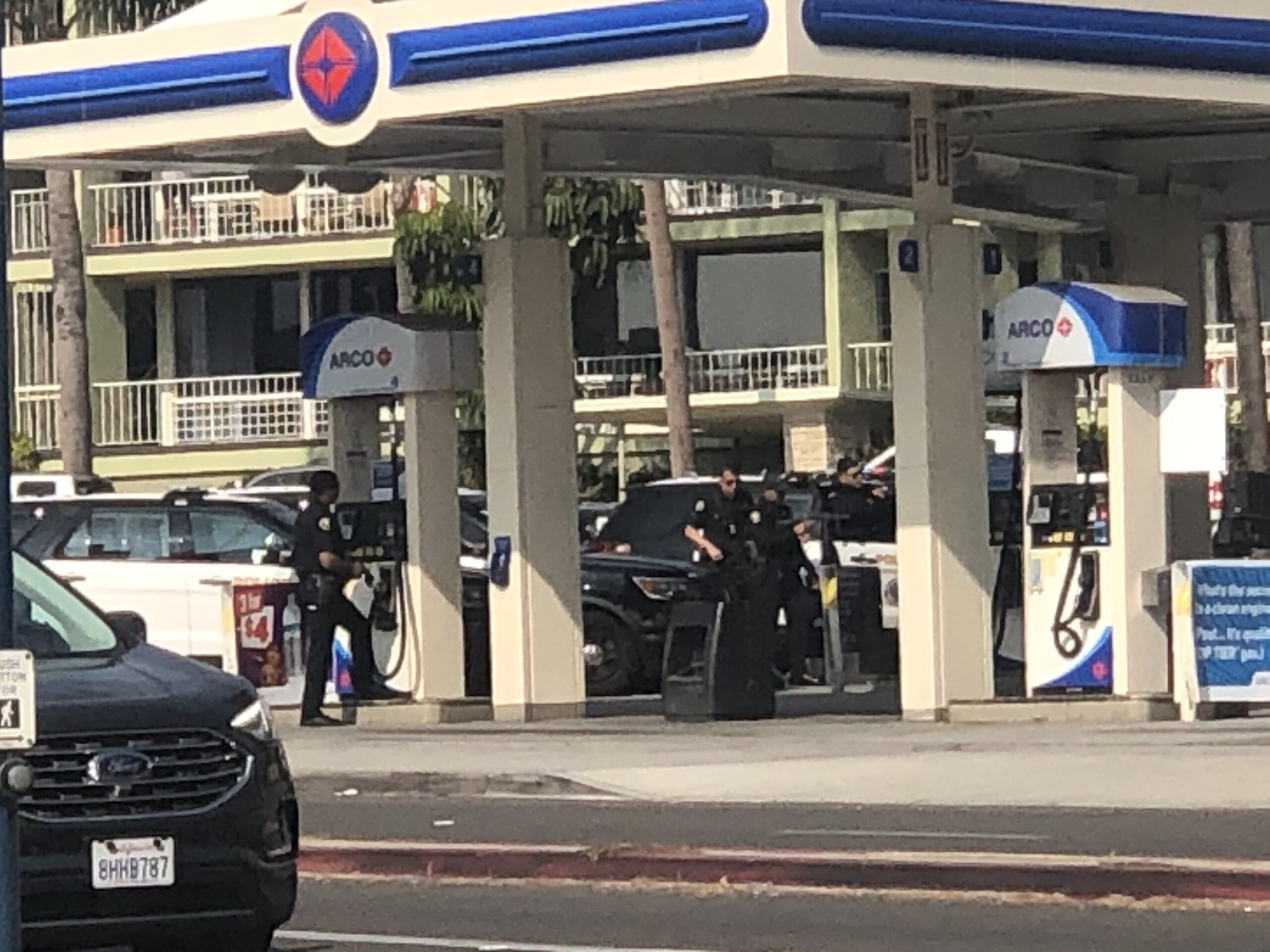 Police at a gas station on Ocean Boulevard in Belmont Shore as they call people out of a stolen car. Courtesy photo.