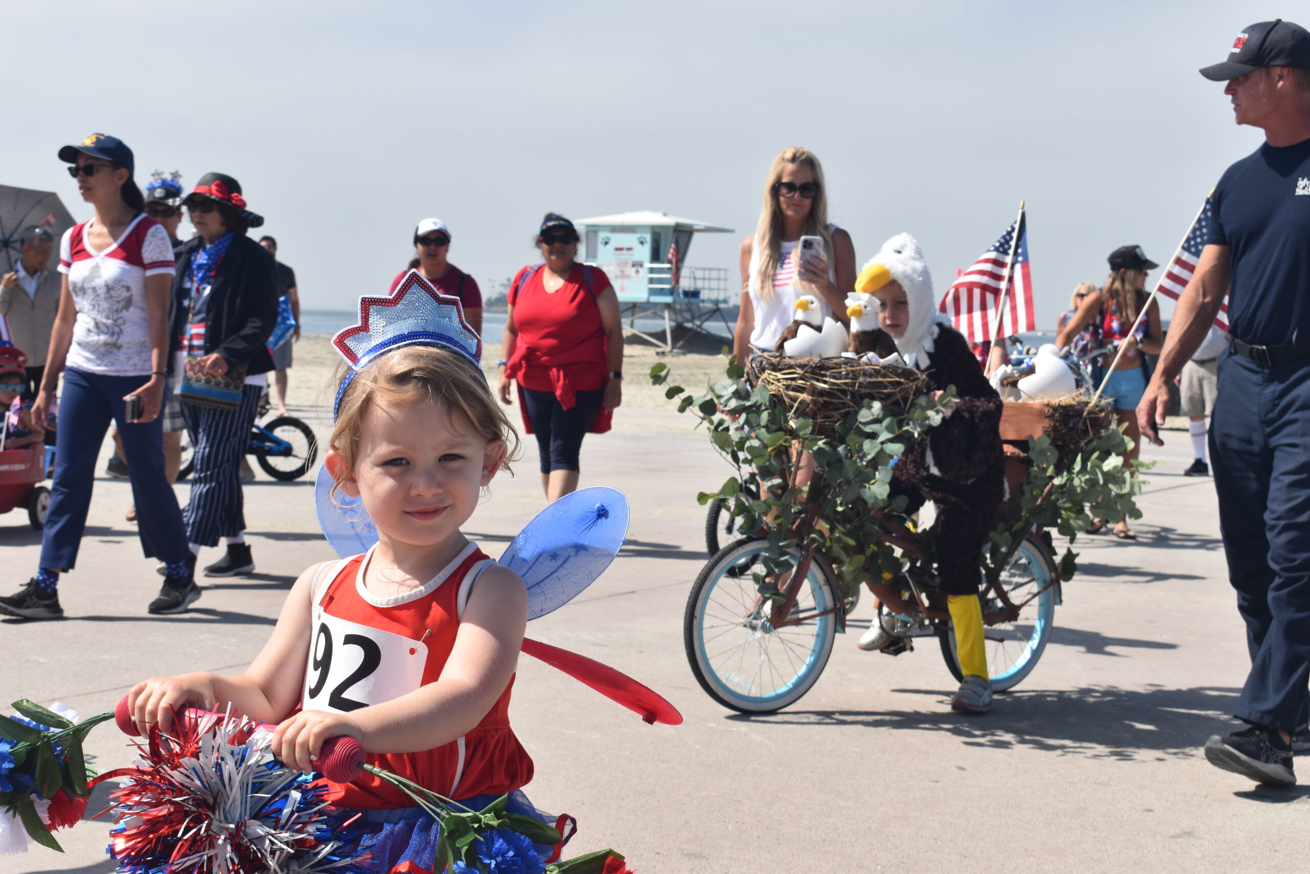 A girl wears a red, white and blue crown and fairy wings at this year's Great American Kids’ Bike Parade in Long Beach on July 4, 2023.