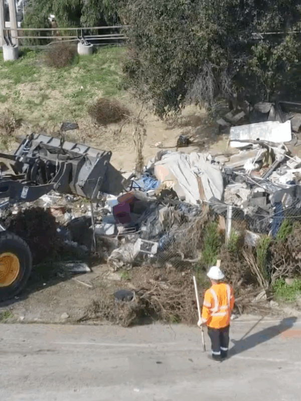State crews clear large freeway encampment in Long Beach, move 25 people into new motel shelter