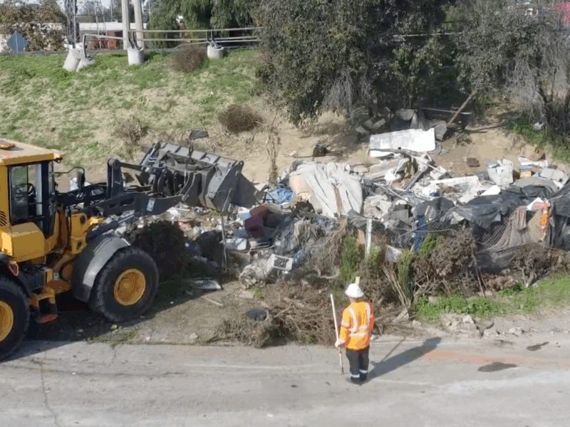 State crews clear large freeway encampment in Long Beach, move 25 people into new motel shelter
