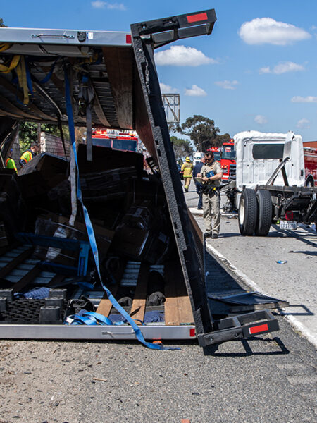 Truck smashes hole into wall on 91 Freeway, spills fuel into lanes