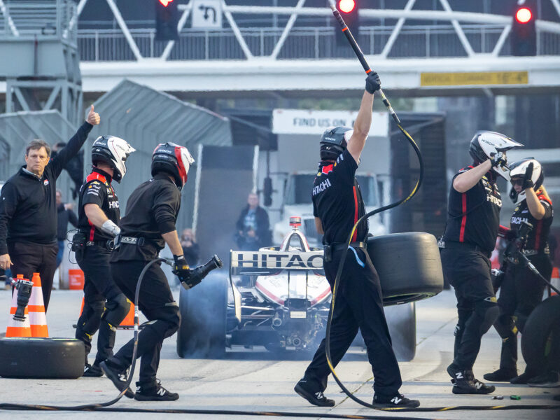 The Indycar pit crew for Josef Newgarden celebrates as they win the pit stop competition during Thunder Thursday at the Pike Outlets.