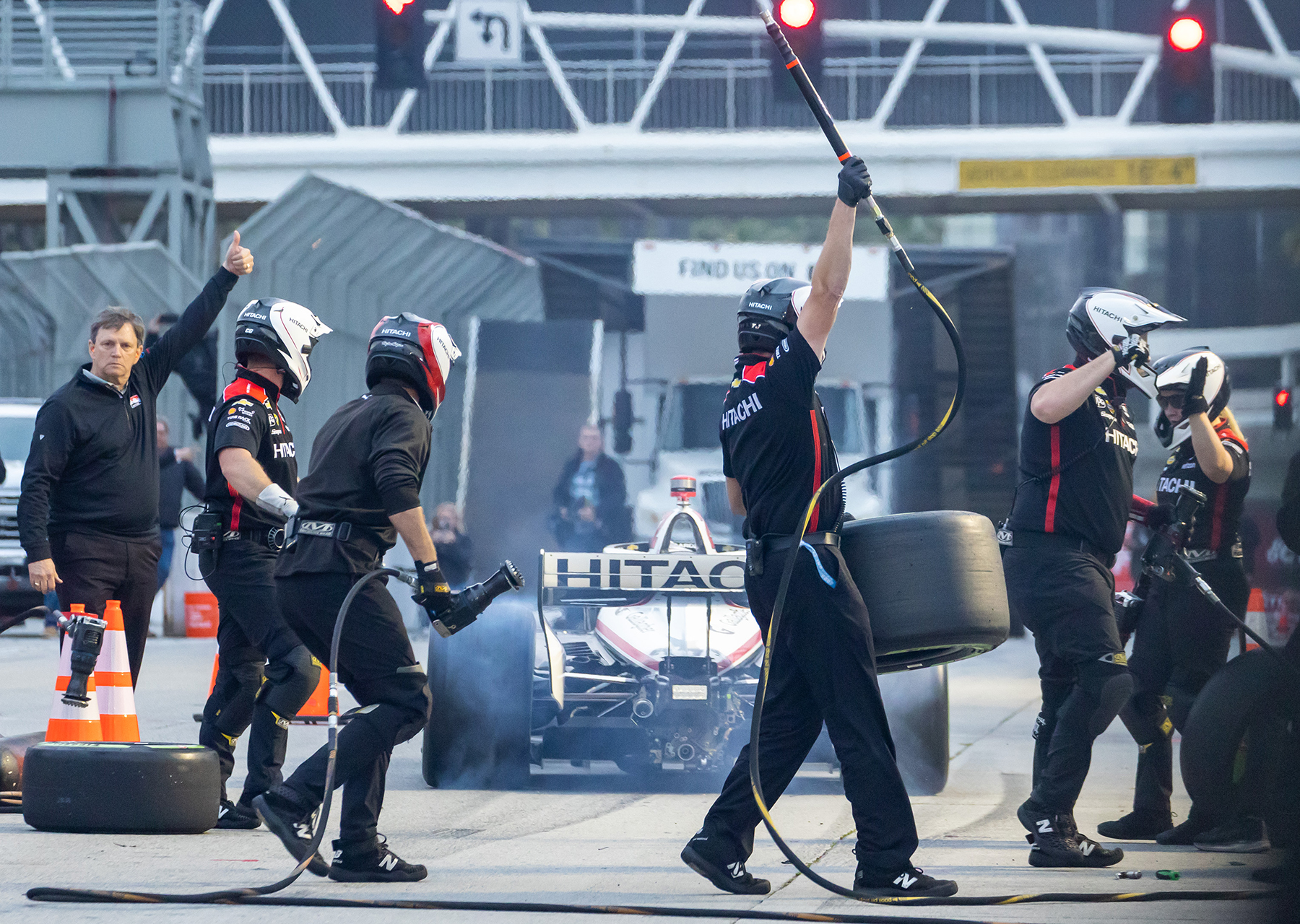 The Indycar pit crew for Josef Newgarden celebrates as they win the pit stop competition during Thunder Thursday at the Pike Outlets.