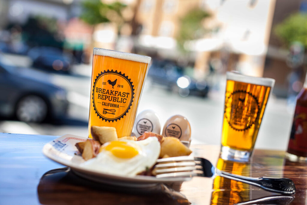 Beers and a breakfast plate are displayed at Breakfast Republic. 