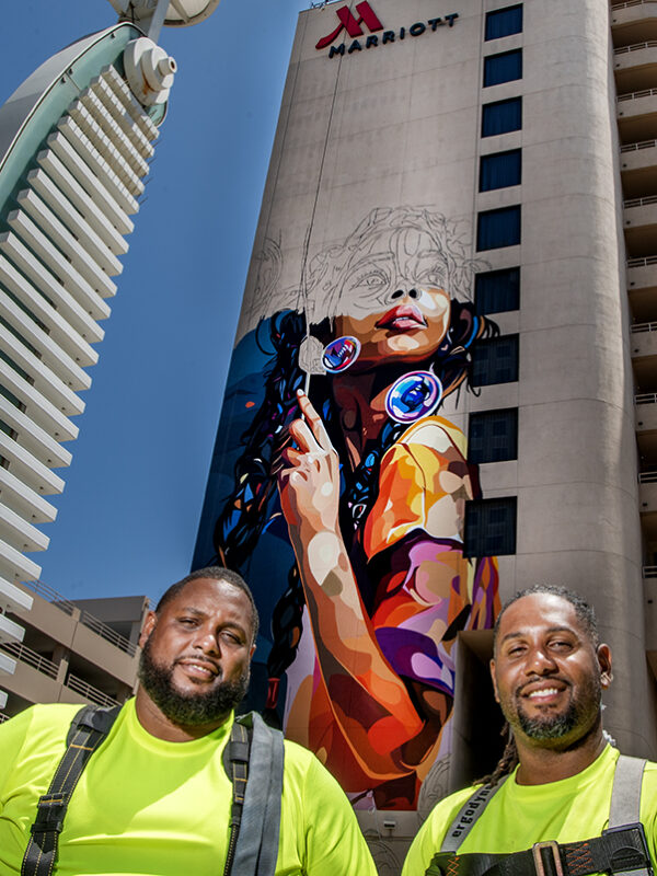 He’s painting a 12-story mural in the heart of downtown; here’s his message of encouragement