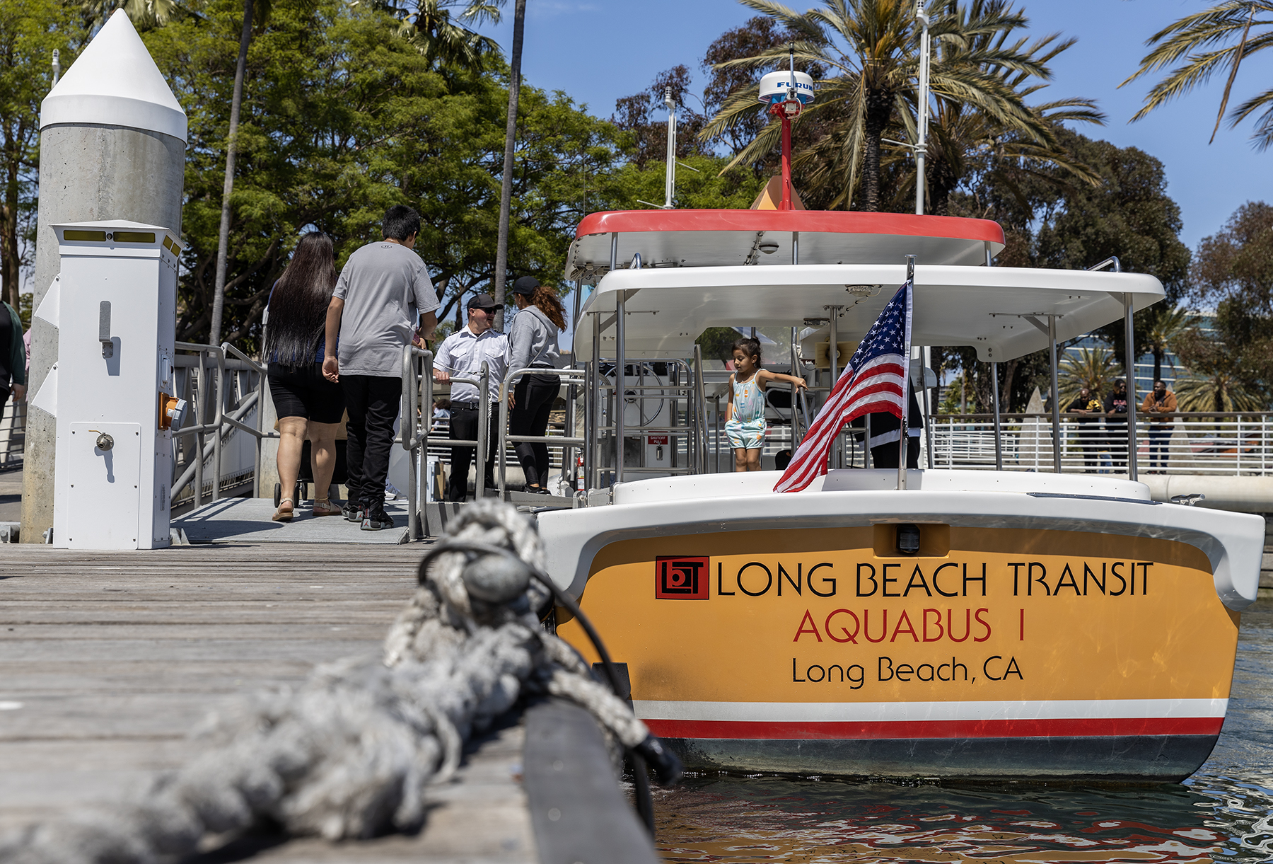 People board and yellow, red and white boat.